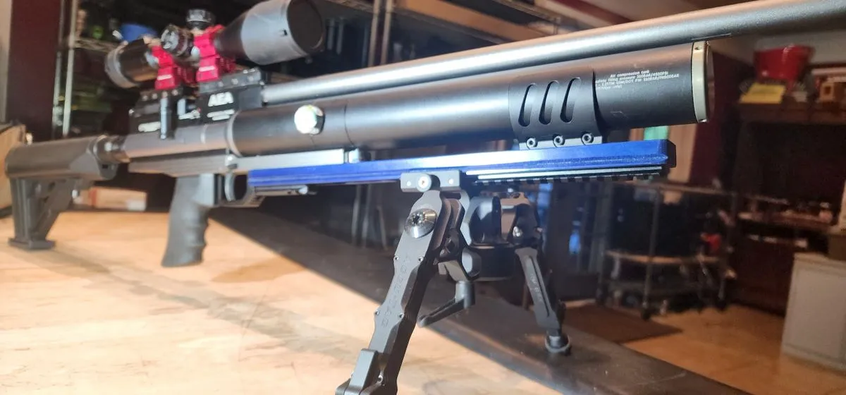 Here's an alt tag for the image: Air rifle with bipod and scope.