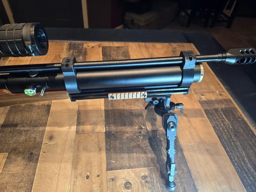 Black air rifle with scope and bipod.