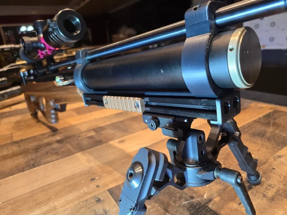 Black PCP air rifle with scope and bipod.