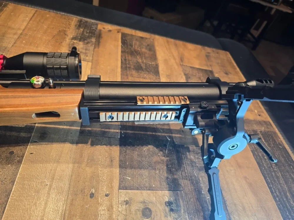 Here's an alt tag for the image: Air rifle with scope and bipod.